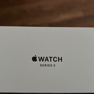 Series 3 Apple Watch with 2 cases and wrist bands.